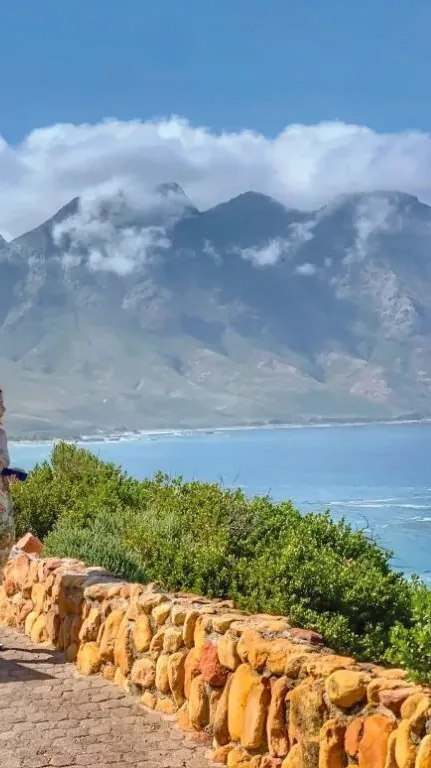 Travelers at a coastal mountain viewpoint along the Garden Route