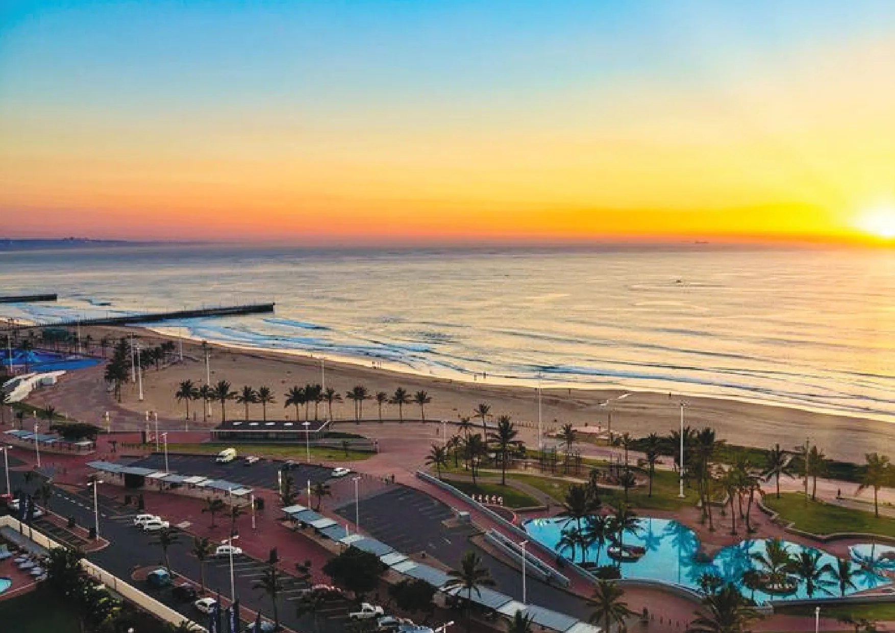 Sunrise over Durban's beachfront promenade and pools
