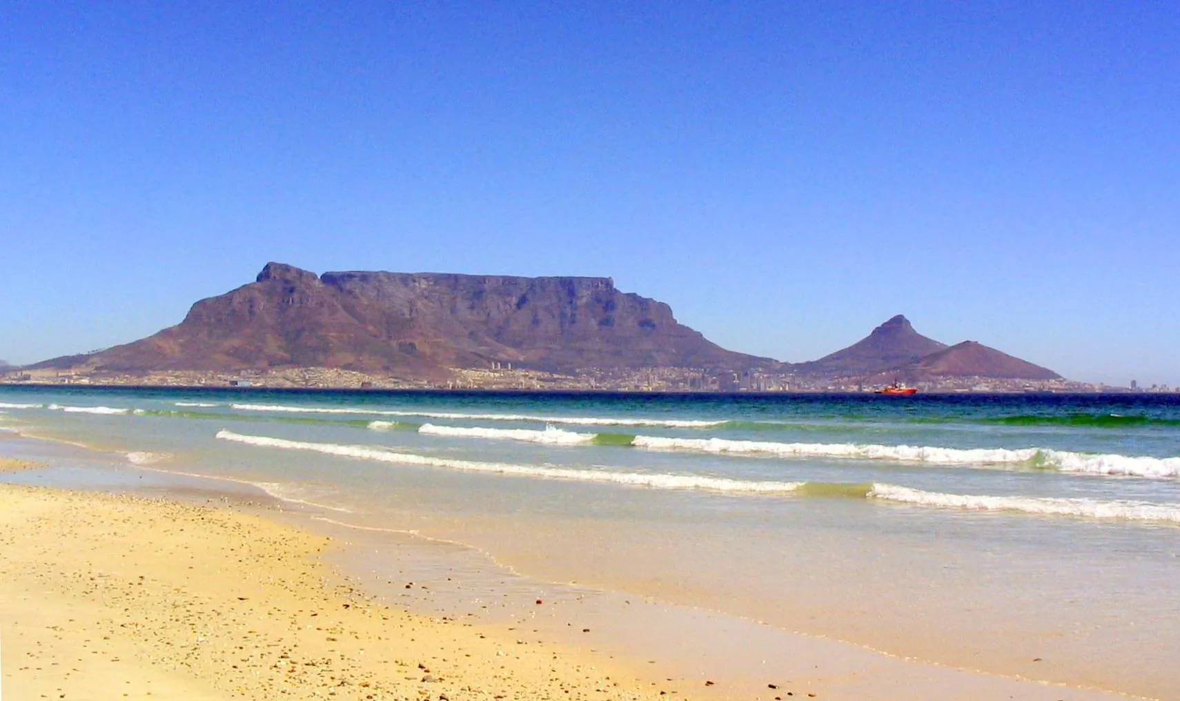 Table Mountain seen across the ocean and beach from the Blouberg coast